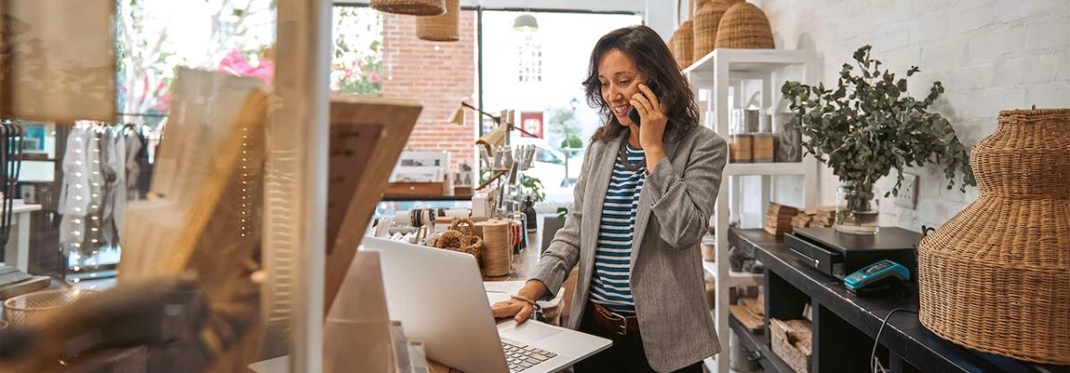 Female business owner talking on a phone.