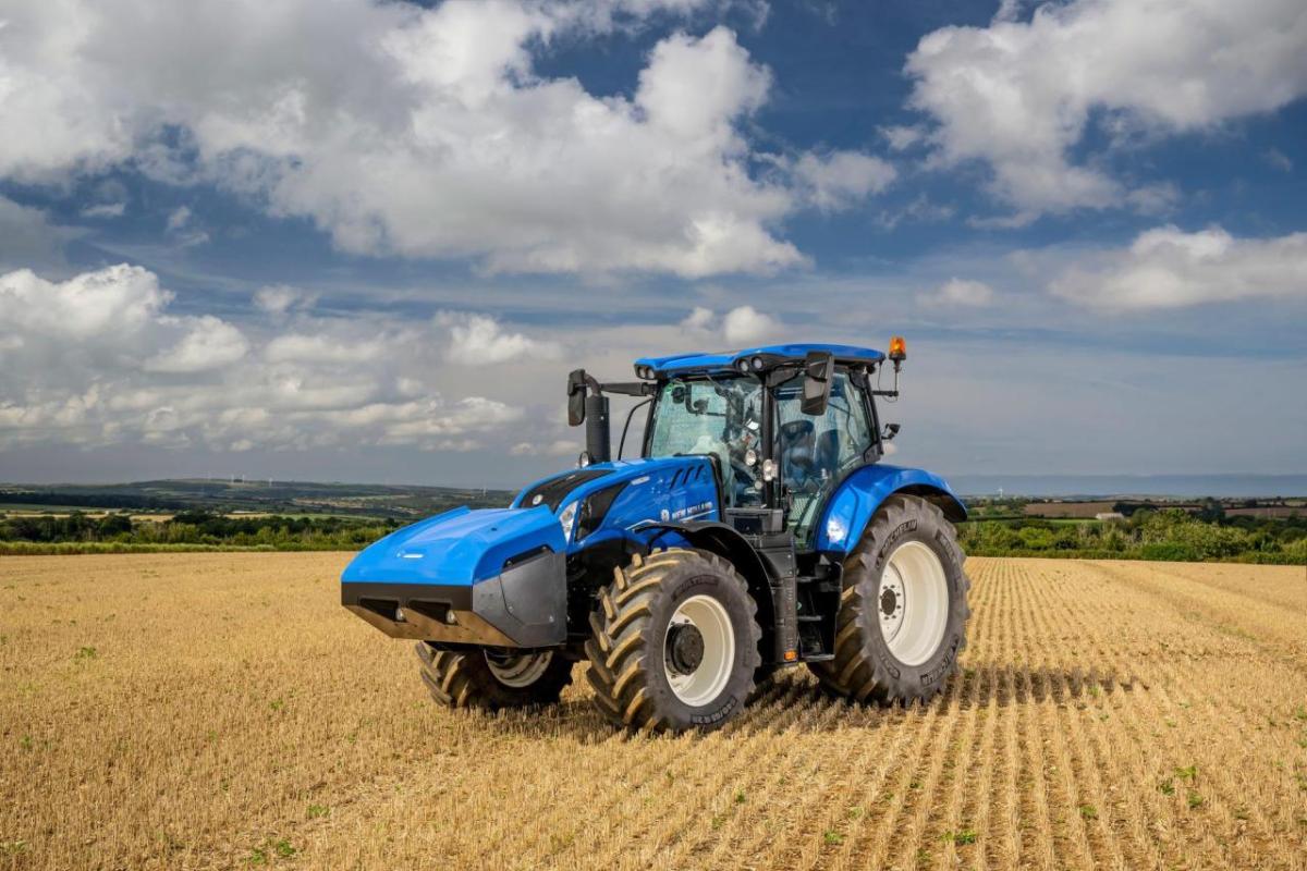 Blue tractor in a crop field 