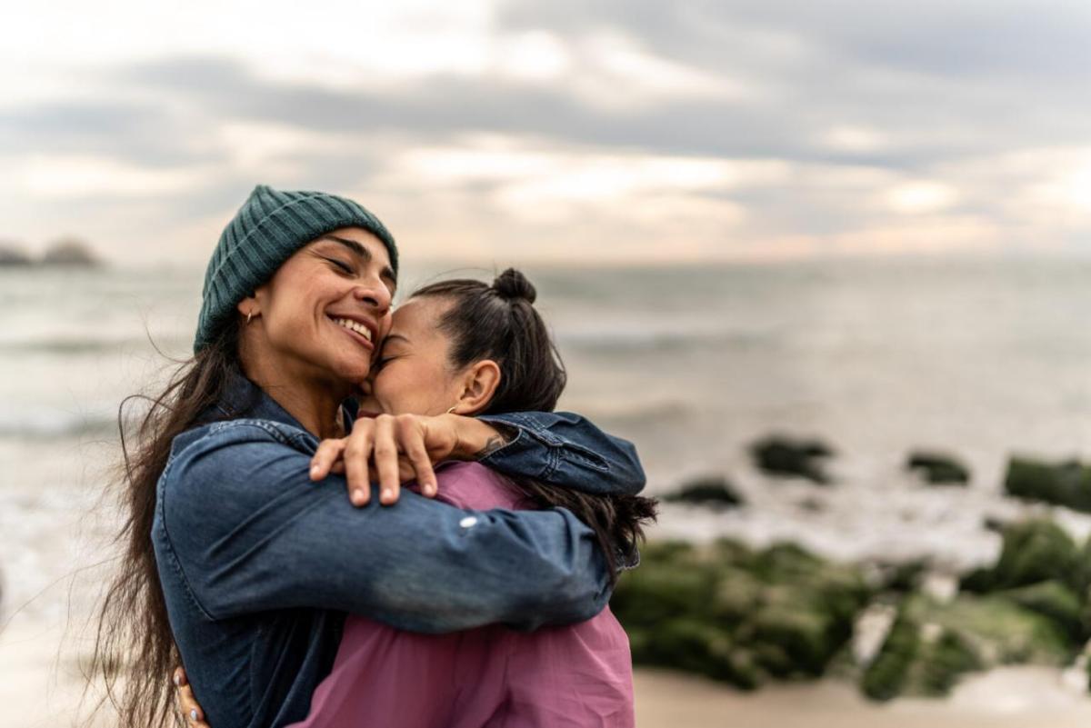 Two people hugging on the beach