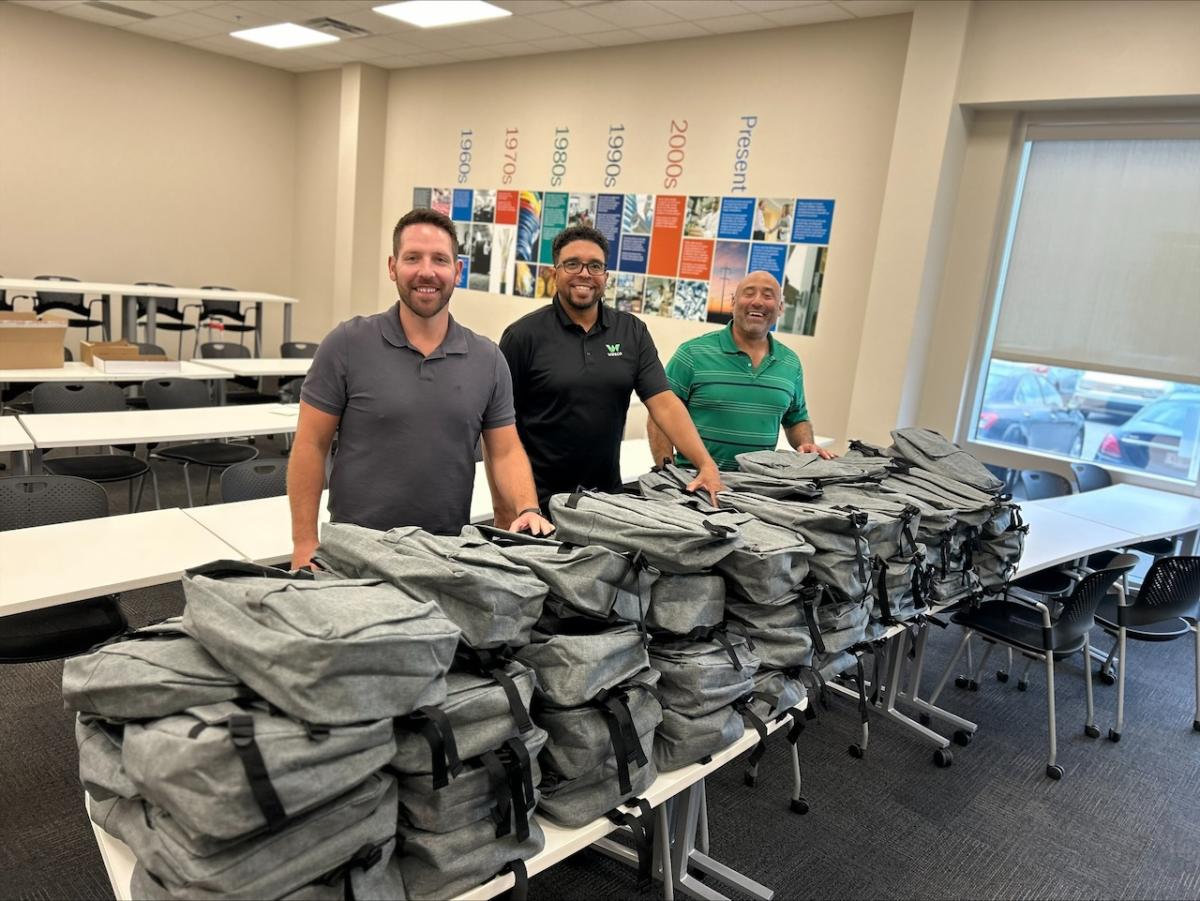 Team members at Wesco shown with backpacks.