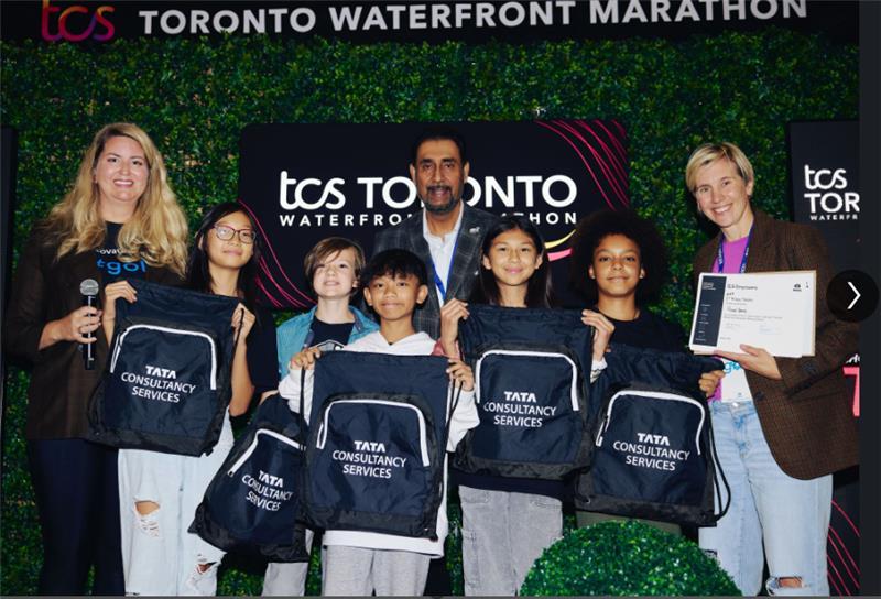 Students holding drawstring Tata Consultancy Services bags