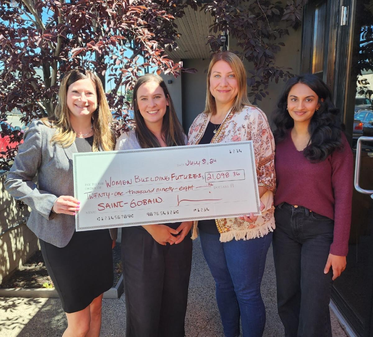 Four women shown holding a grant check from Saint-Gobain for $21,098.