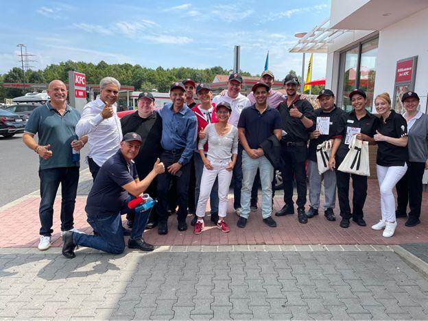 A group photo taken outside of a KFC restaurant 