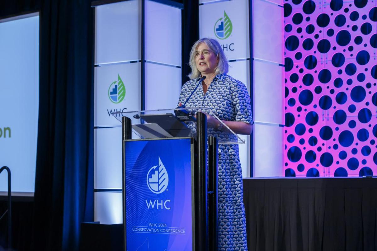 Margaret O'Gorman speaking onstage at the 2024 WHC Conservation Conference