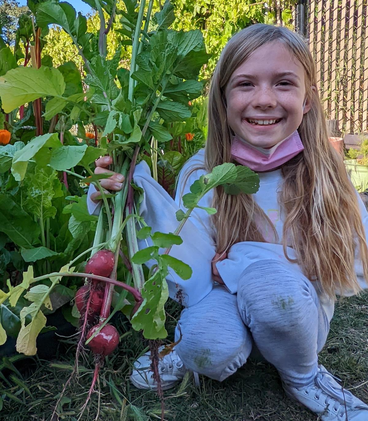 A child holding radishes