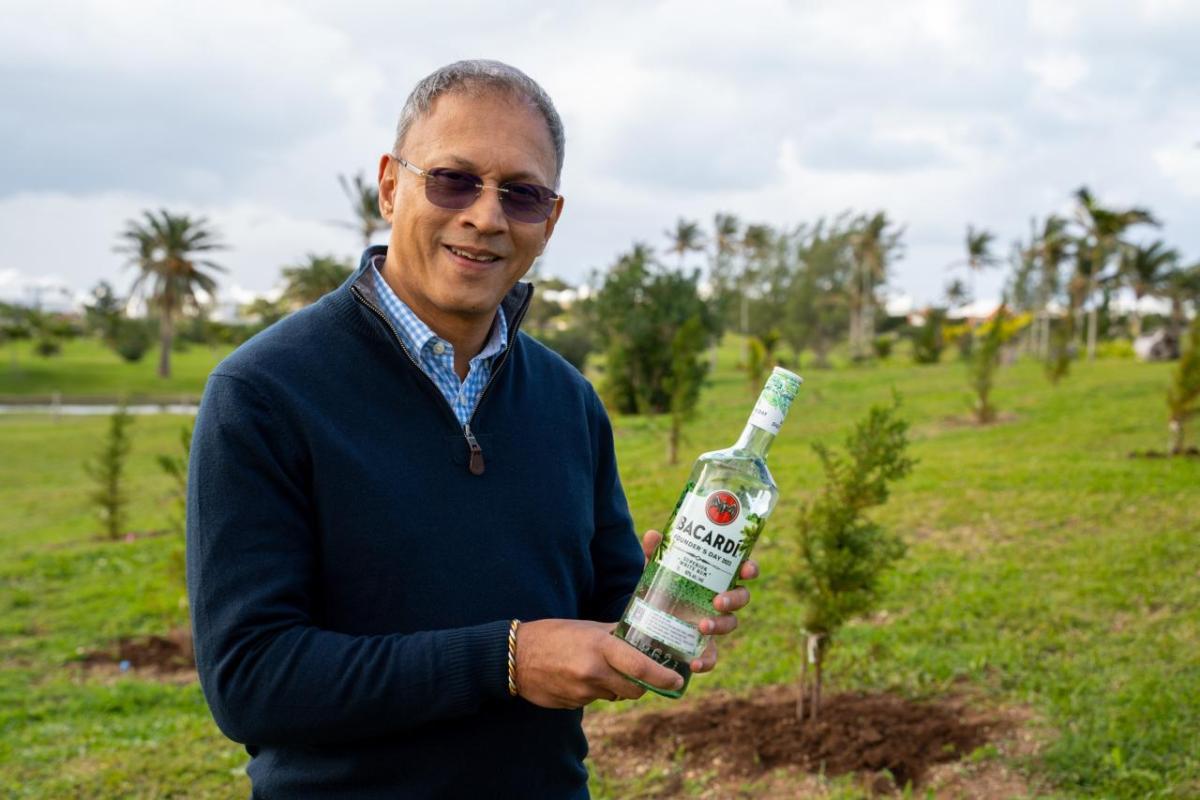 CEO Mahesh Madhavan with a Bacardi bottle