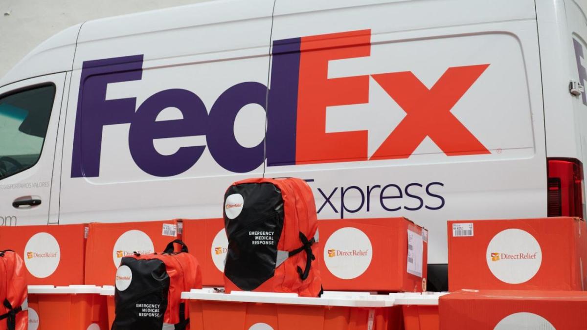 A FedEx express van, Boxes and backpacks with Direct Relief logos in front.