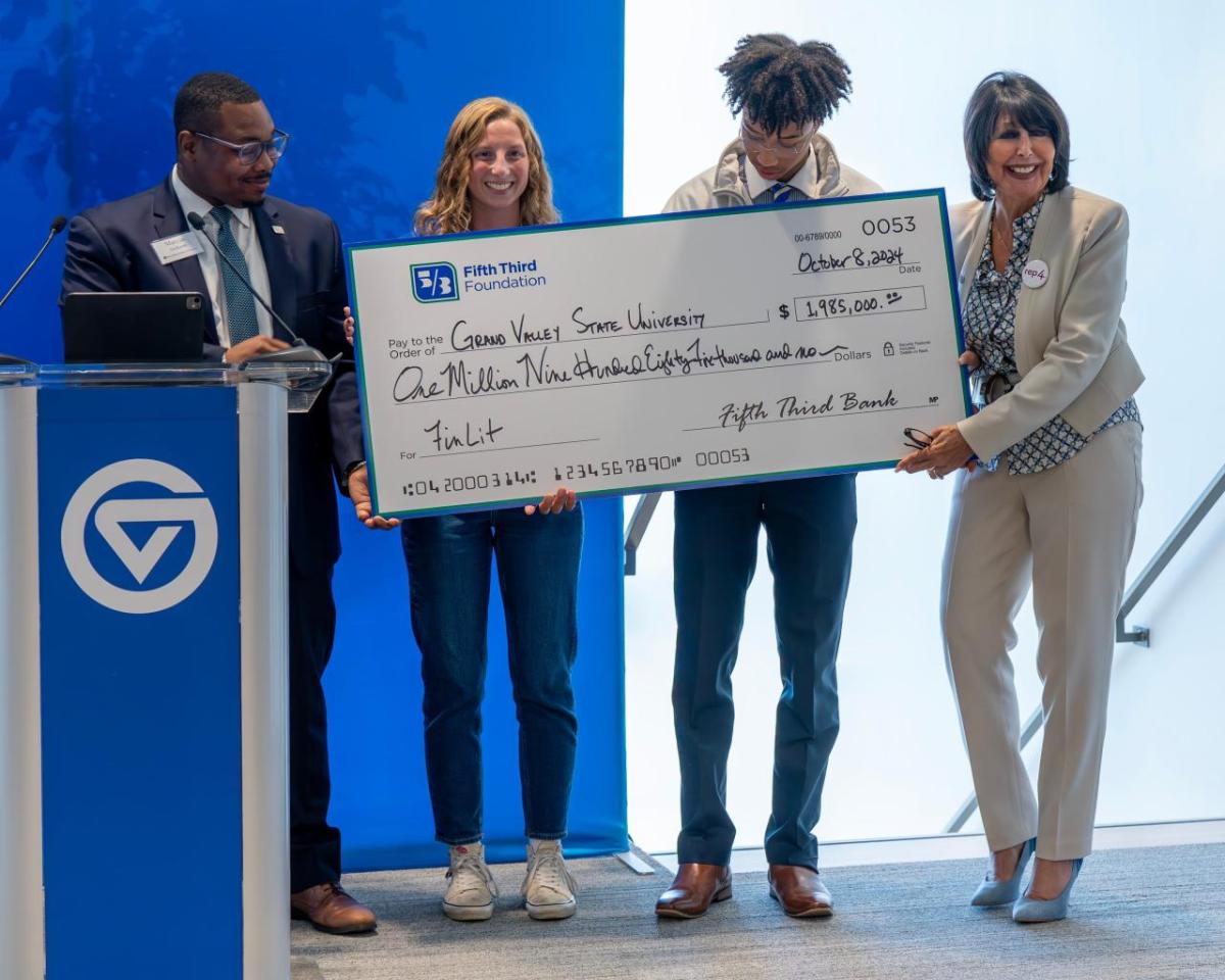 Small group receiving check on stage 