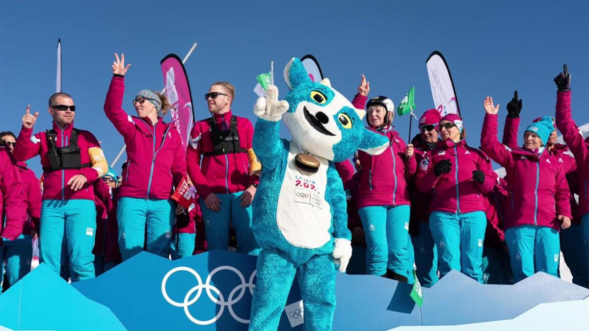 group of people in warm clothing with a mascot