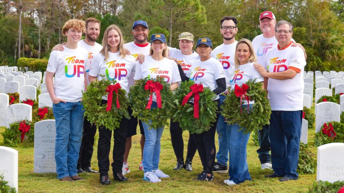 group posing with wreaths 