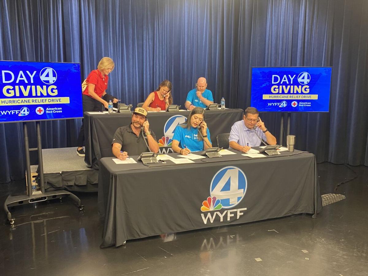 Volunteers on phones during a fundraising event. "Day 4 giving" on screens beside them.