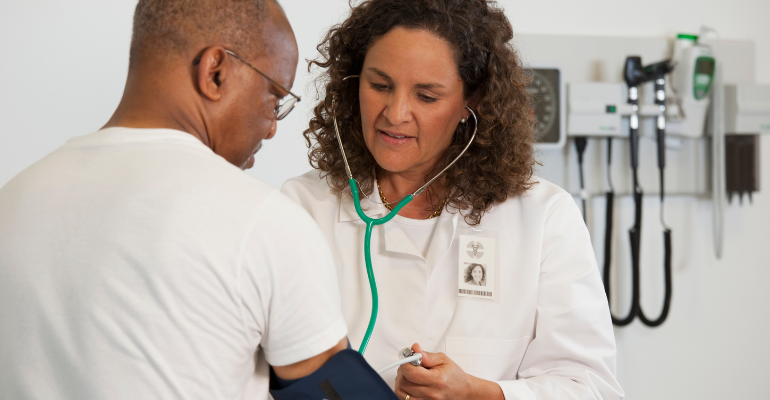 Doctor taking a patients blood pressure