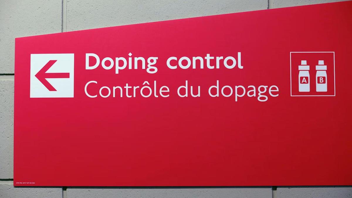 A red sign "Doping control" and an arrow pointing left.