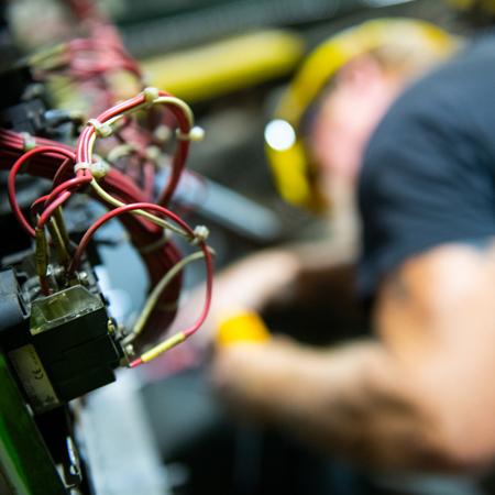 electrician, out of focus, with wiring in the foreground