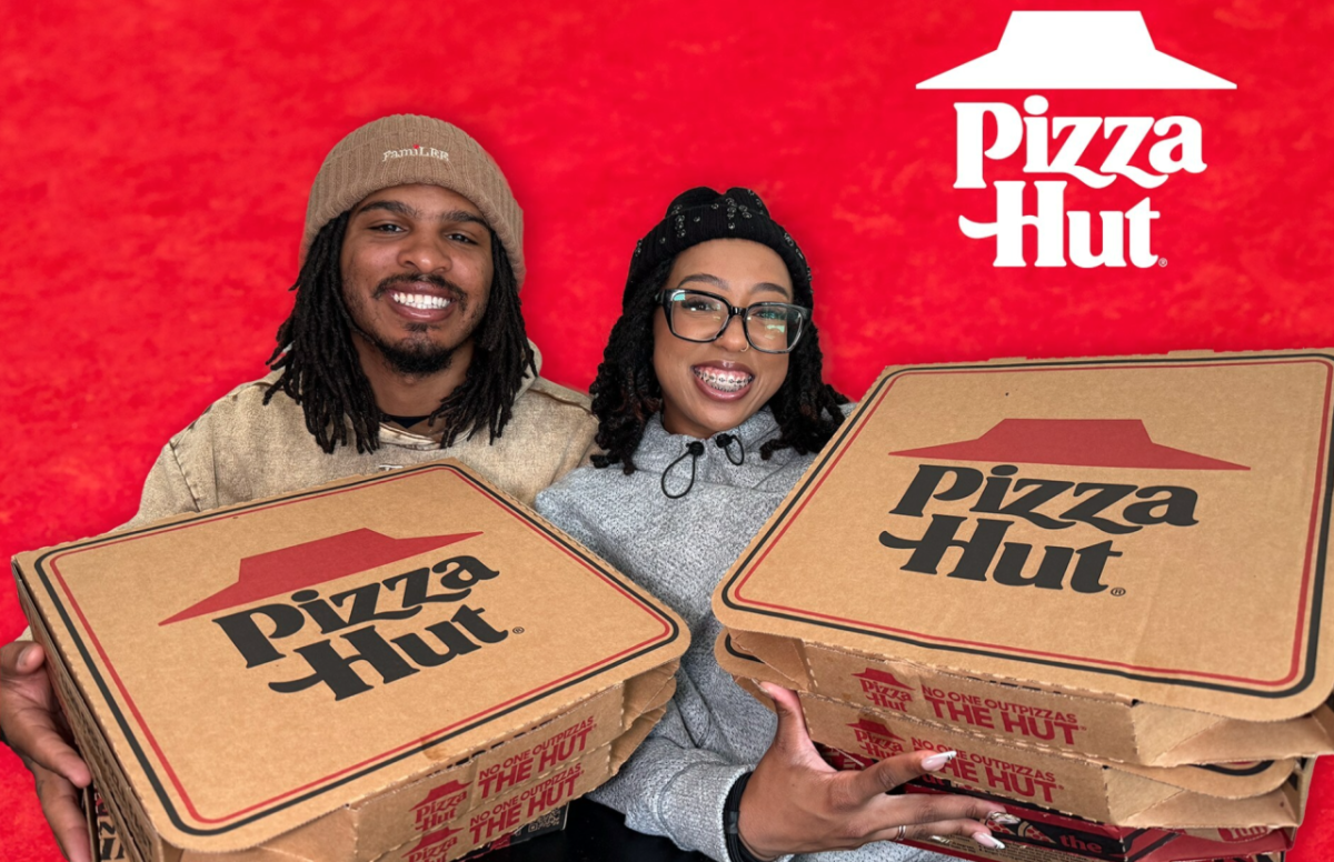 Keith Lee and his wife holding pizza hut boxes