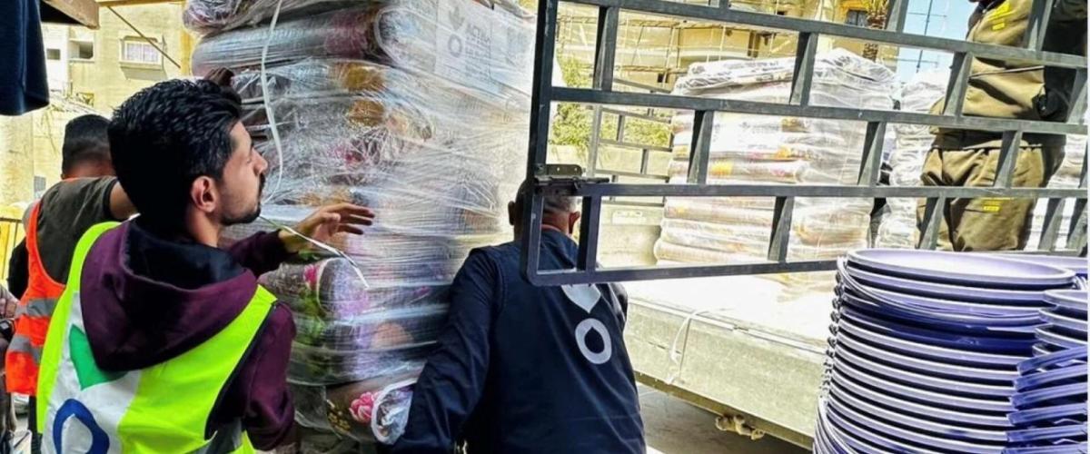 workers carrying a pallet of supplies