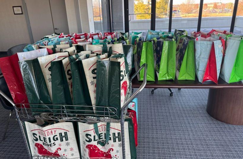 A table and cart full of gift bags.