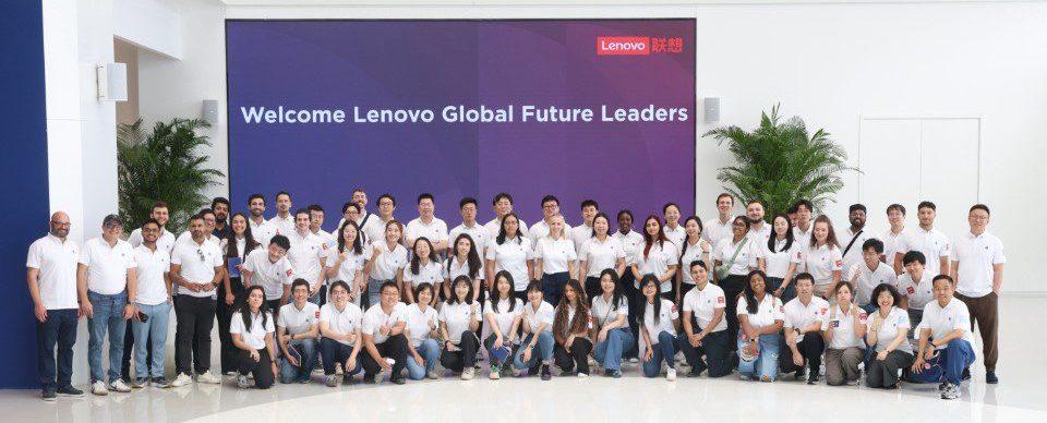 A group posed in matching shirts in front of a sign "Welcome Lenovo Global Future Leaders"