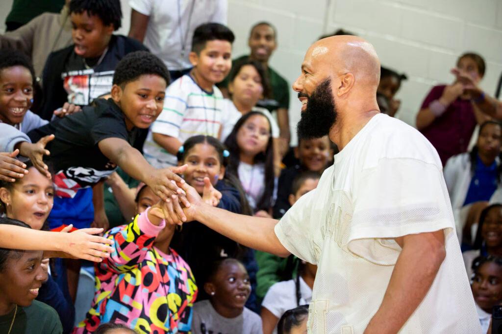 An adult reaching out to an audience 