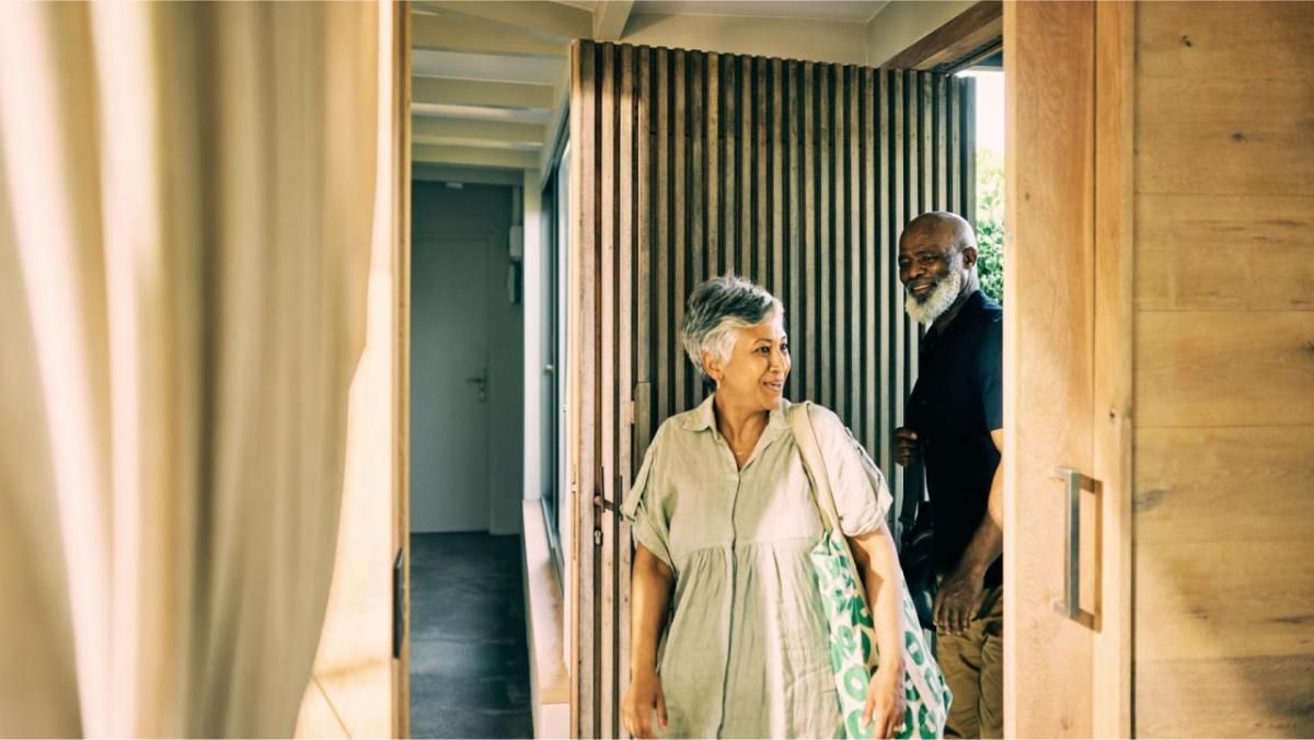 Two people entering a building 