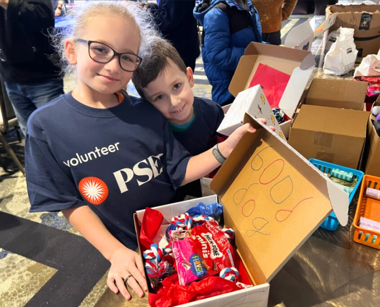 2 kids with donation boxes