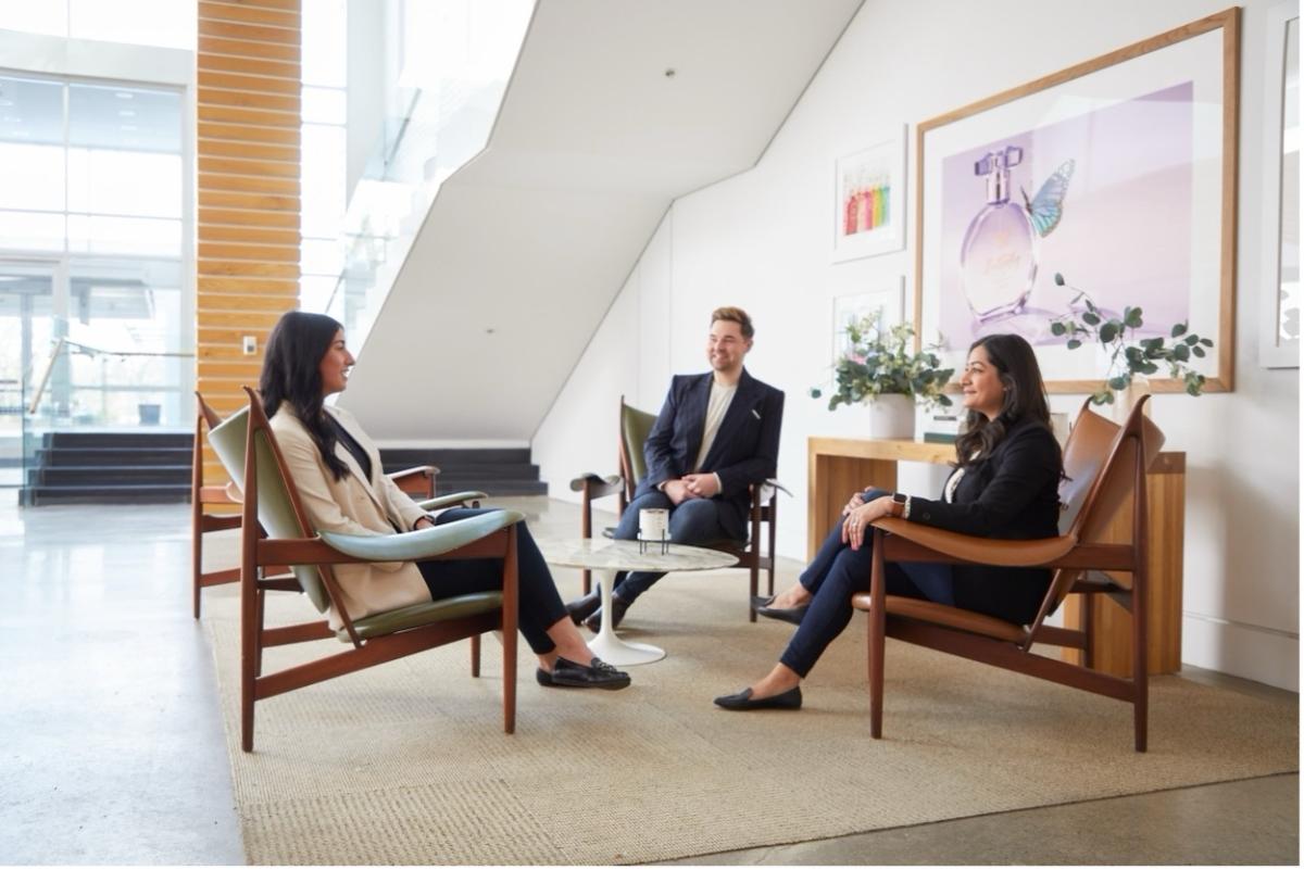 3 people sitting in a meeting