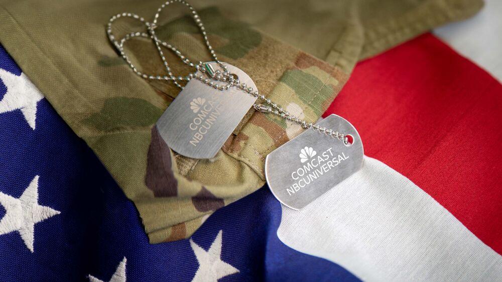 Military uniform and 'dog-tags' on an American flag.