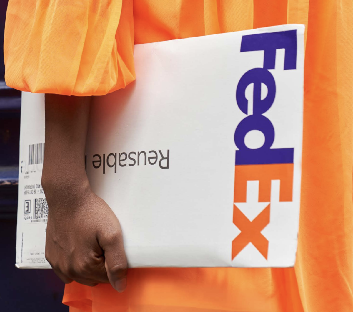 person holding a FedEx package