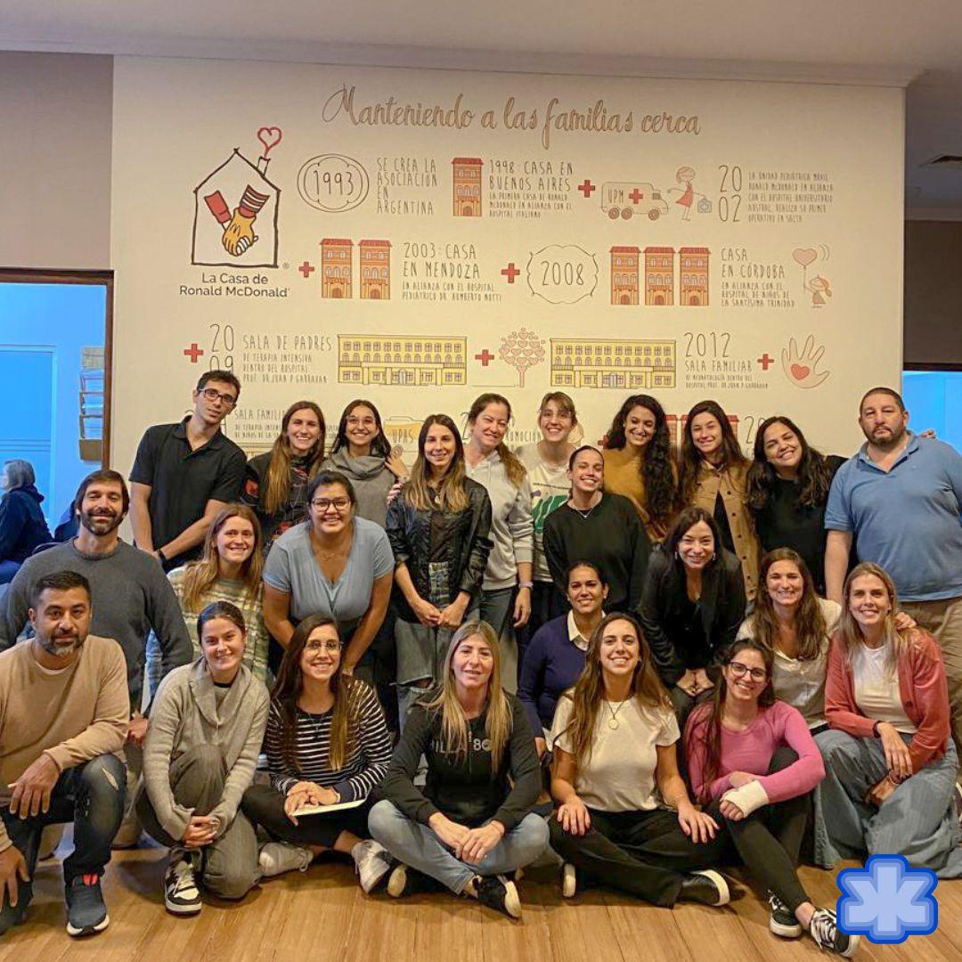 Group posed in front of a Ronald McDonald house sign.