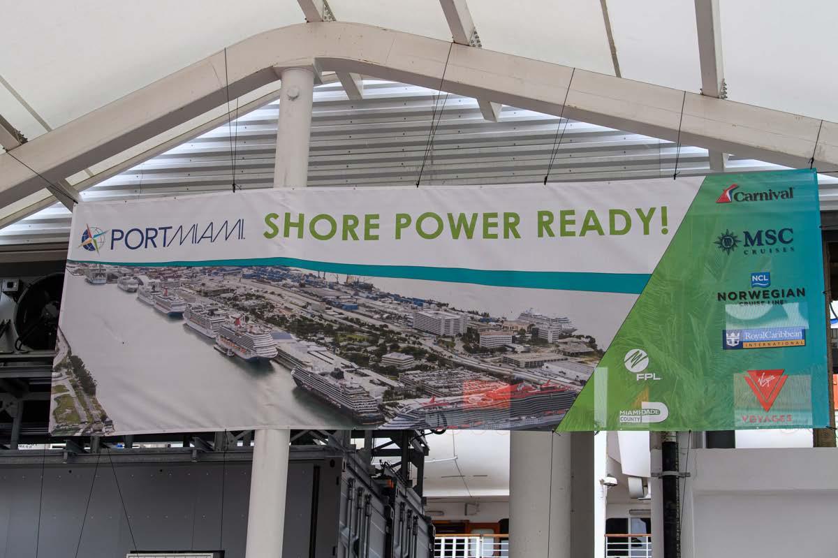 A banner hung from steel rafters "PortMiami Shore Power Ready".