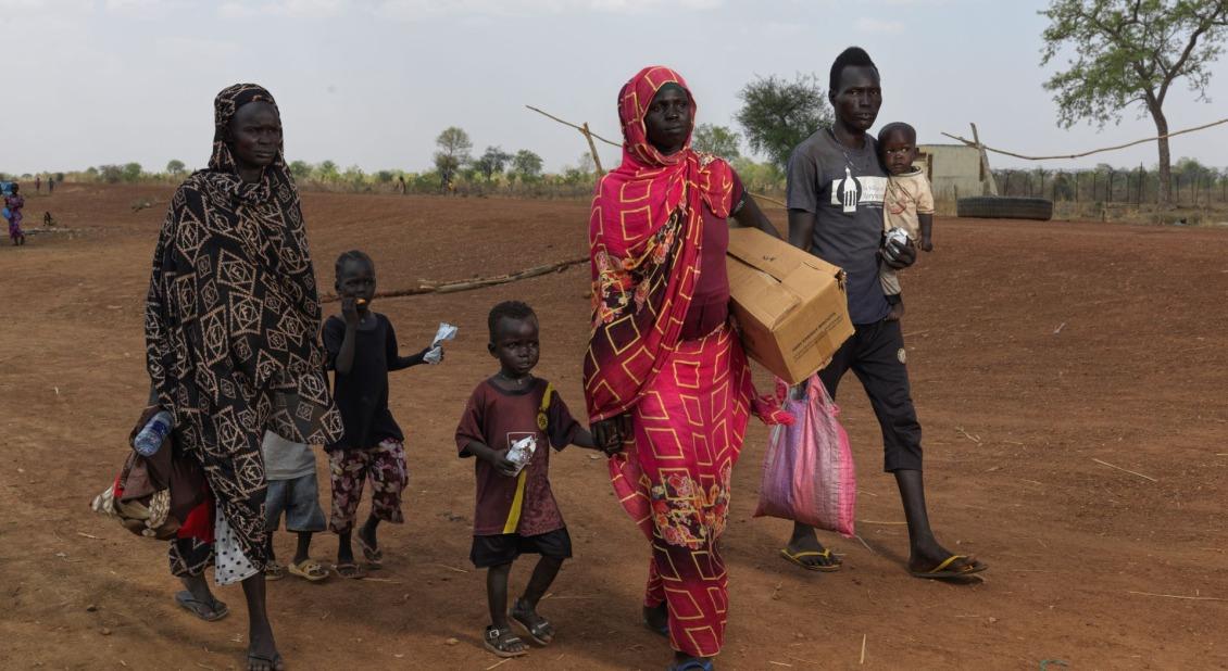 A displaced family crosses the border into South Sudan. / Photo by Peter Caton