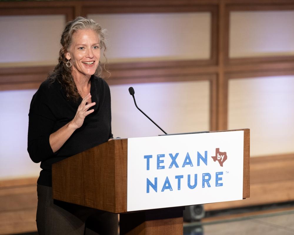 Joni Carswell speaking at a podium