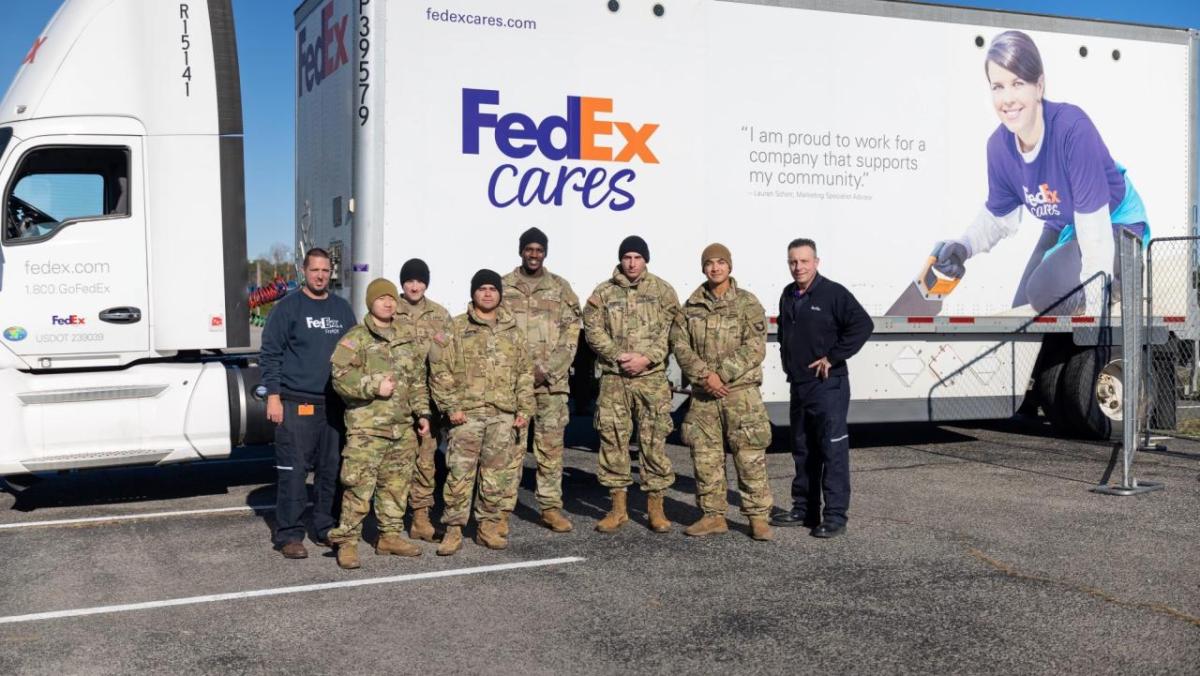 Group photo in front of FedEx Cares truck