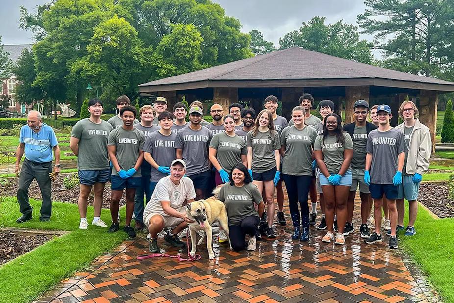 The group of volunteers posed in a park setting.