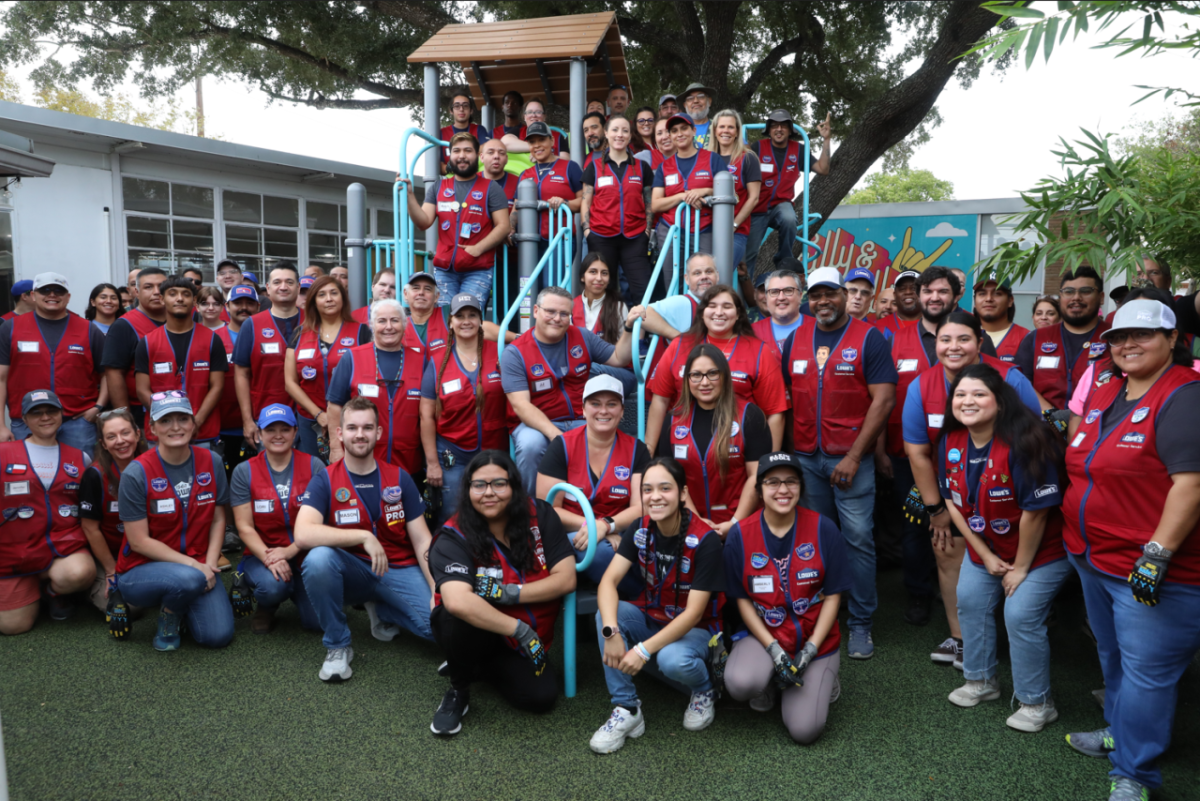 Lowe’s Volunteers pose on a newly built playground.