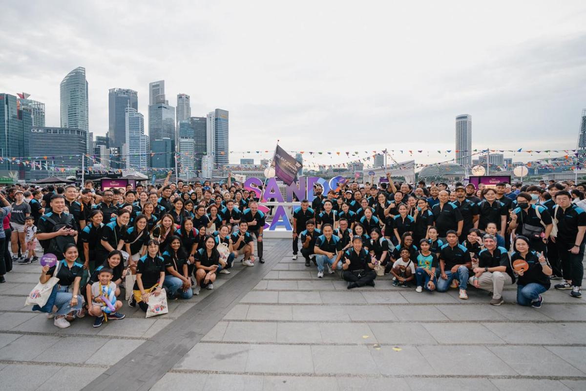 A large group of volunteers posed outside