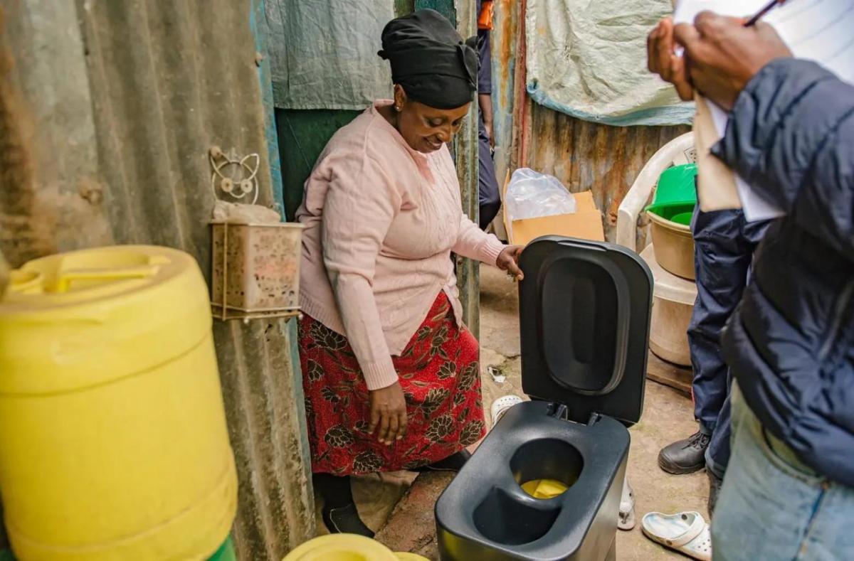 A person looking over a Loope toilet