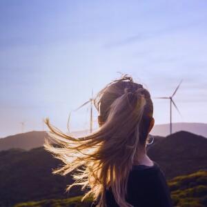 Woman looking at windmills
