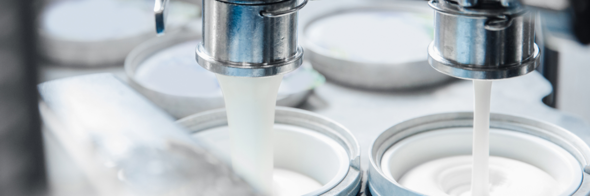 close up of a dairy product being filled into containers