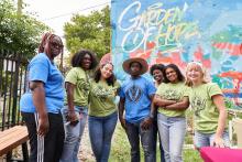 Seven people posing together in a garden: \"Garden of Hope\"