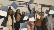 students displaying certificates