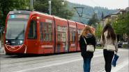 Two people walking next to a train