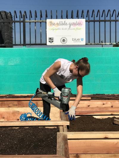LA Kings staff nail together a planter filled with dirt at the Weingart YMCA Wellness & Aquatic Center as part of the combined efforts of the Kings, Enrich LA and Blue Shield of California on January 31, 2018.