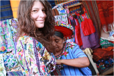 Jaimee is being dressed in a guipil, a traditional outfit, blouse and skirt, the pattern and colors of which indicated which village the woman wearing it is from.