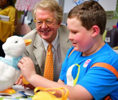 Aflac CEO Dan Amos and 13-year-old Ethan Daniels admire the innovative My Special Aflac Duck at a ceremony held at the Aflac Cancer and Blood Disorders Center in Atlanta earlier this year. Aflac has a goal of providing one -- free of charge -- to every newly diagnosed child, ages 3-13 in the United States.