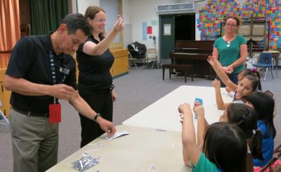 SCE engineers Lindsey Sayers and Edgar Pabon-Hernandez show the girls of Troop 6941 how to build their own electrical circuits as part of National Engineers Week.