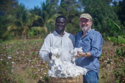 Timote Georges, co-founder and country director, (left) and Hugh Locke, co-founder and President, of the Smallholder Farmers Alliance celebrate Haiti’s first commercial cotton harvest in 30 years. The Smallholder Farmers Alliance, in partnership with Timberland and others, aims to reintroduce cotton farming to Haiti to benefit famers, customers, and the environment. (Photo: Thomas Noreile/SFA)