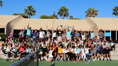Athletes, staff and volunteers celebrate the conclusion of the 2016 Return the Serve Fun Day with a silly group photo at StubHub Center.