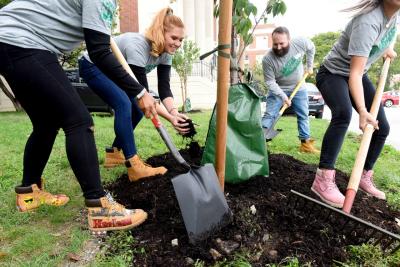 Timberland volunteers pull on their boots at Manhattan Center for Science and Mathematics as part of the brand’s Urban Greening initiative, Wednesday, Oct. 17, 2018, in New York. Timberland has pledged to create or restore another 500,000 square feet of green space in U.S. cities over the next 5 years. (Diane Bondareff/AP Images for Timberland)