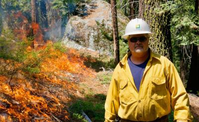 Stephen Byrd, SCE manager of forestry at Camp Edison and Shaver Lake, works on a prescribed burn. Credit: Galen Nishioka, Circle Feather Films